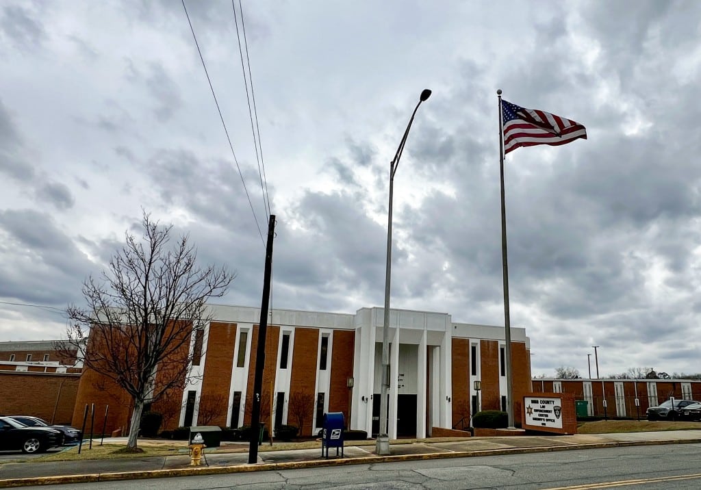 The outside of the Bibb County jail with a flag pole in front