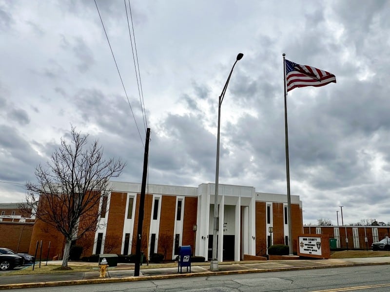 The outside of the Bibb County jail with a flag pole in front