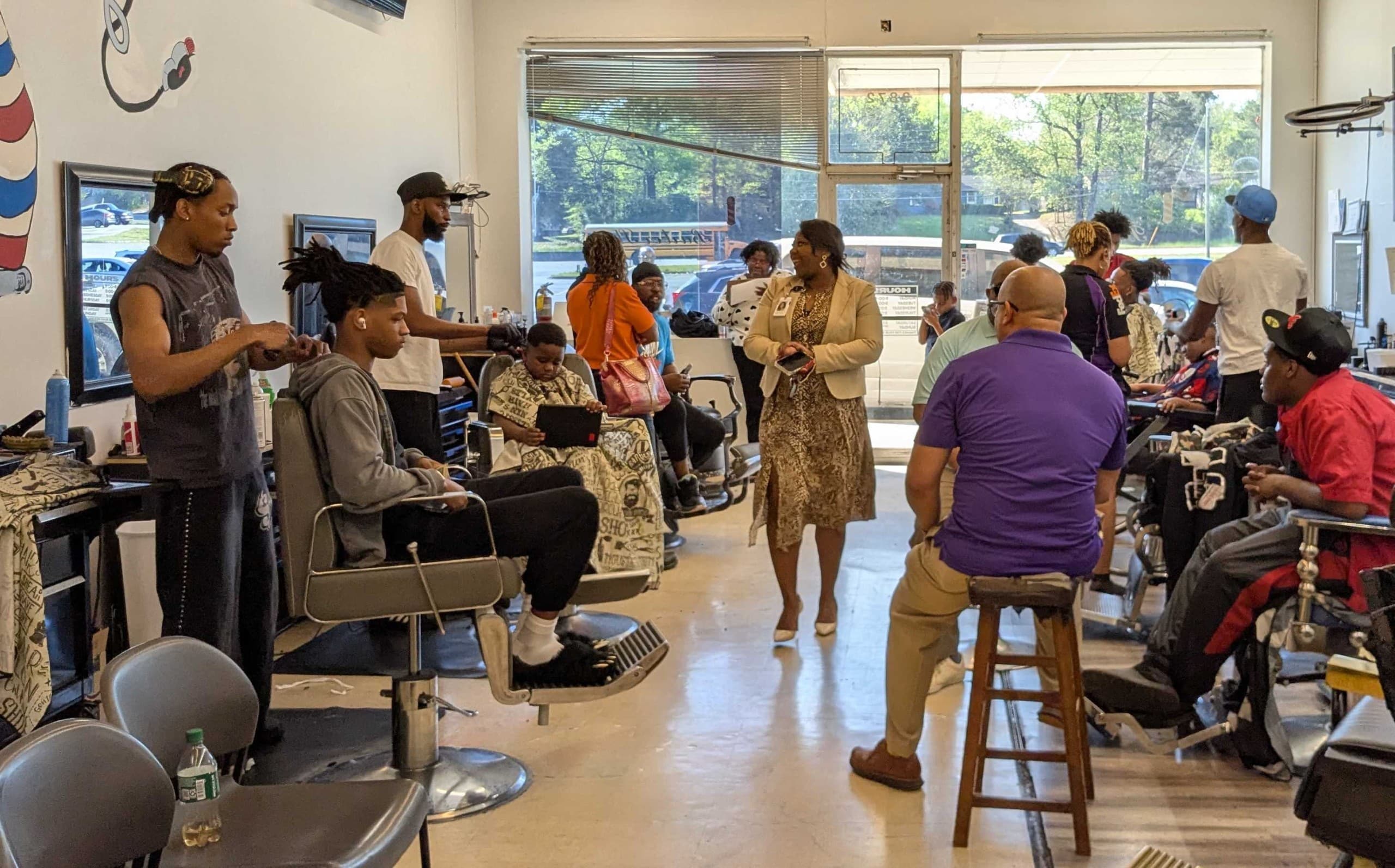 School officials take their message on truancy and literacy concerns to Macon barbershops